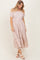 woman wearing a striped pink and white tiered maxi dress with short puff sleeves and a relaxed fit
