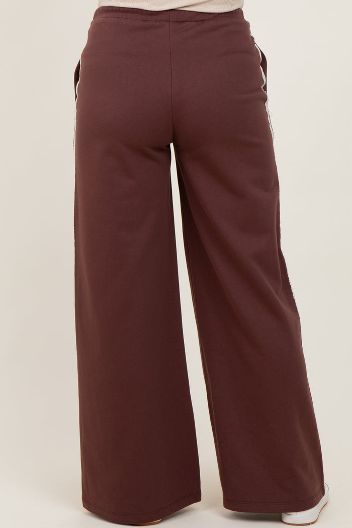 maternity wear in a burgundy wide-leg sweatpants style, shown from the back