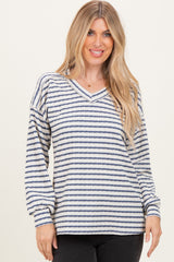 woman wearing a white and navy striped long sleeve v-neck top with relaxed fit and balloon sleeves