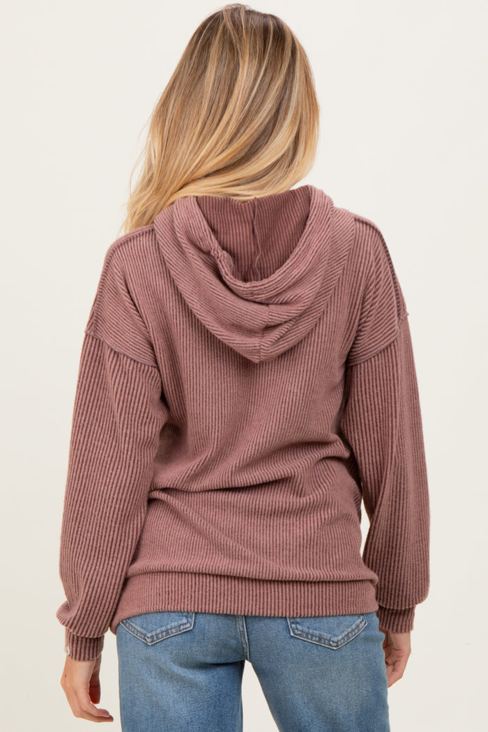 woman wearing a mauve ribbed maternity hoodie with a hood, shown from the back
