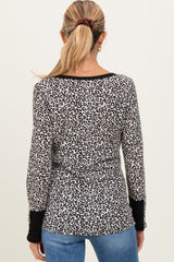woman wearing a maternity long sleeve leopard print top with a black trim and back view displayed