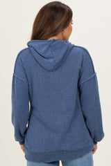 woman wearing a blue ribbed maternity hoodie with a hood and relaxed fit, showing the back view