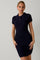 woman wearing a navy short sleeve cable knit polo dress with a fitted silhouette