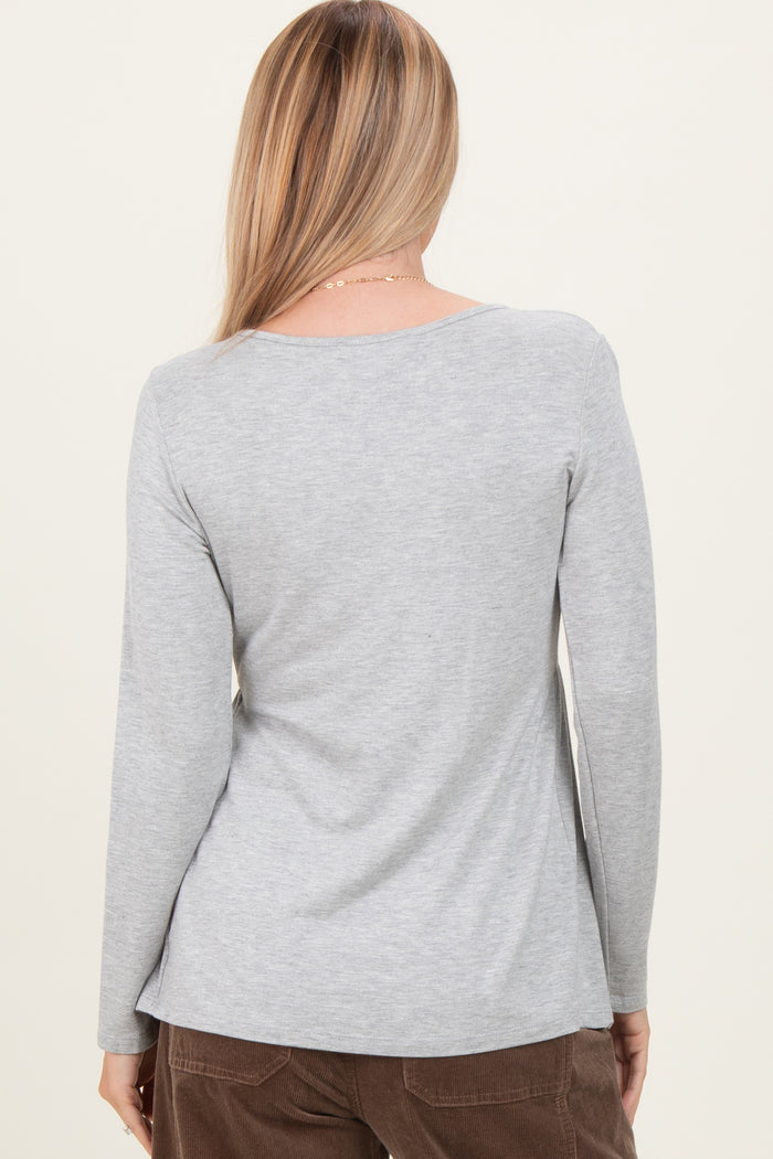 woman wearing a gray long sleeve top, viewed from the back, with a relaxed fit and soft fabric