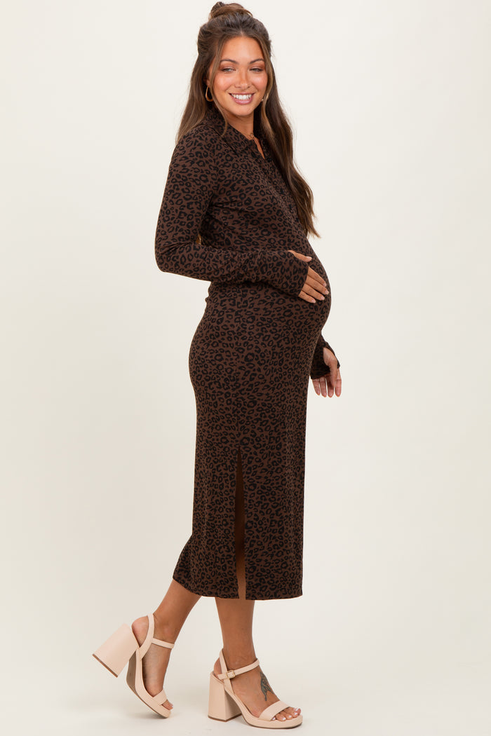 woman wearing a brown leopard print maternity dress with side slits and holding her baby bump