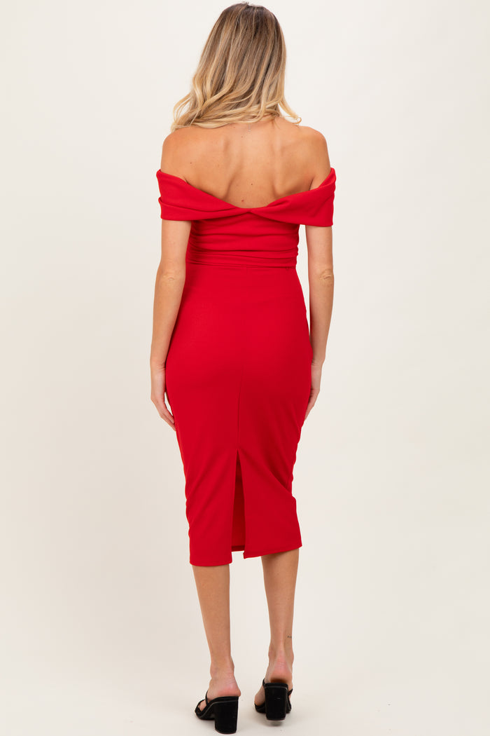 woman wearing a red off-the-shoulder maternity dress with a fitted silhouette and back slit, showing her baby bump