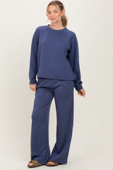 woman wearing a navy blue oversized sweatshirt and matching wide-leg jogger pants