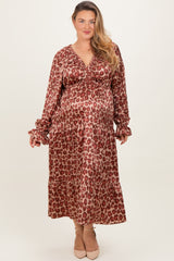 woman wearing a red and brown leopard print maternity dress with long sleeves and ruffle details, showing her baby bump