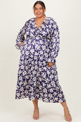 woman wearing a purple floral plus size maternity maxi dress with long sleeves and pockets, showing her baby bump
