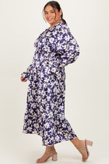 woman wearing a floral print long sleeve maxi dress in purple with a cinched waist and ruffled details