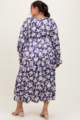 plus size woman wearing a floral purple maxi dress with long sleeves and tiered hem, viewed from the back
