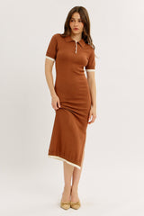 woman wearing a brown ribbed midi dress with short sleeves and a polo collar, featuring white trim at the sleeves and hem