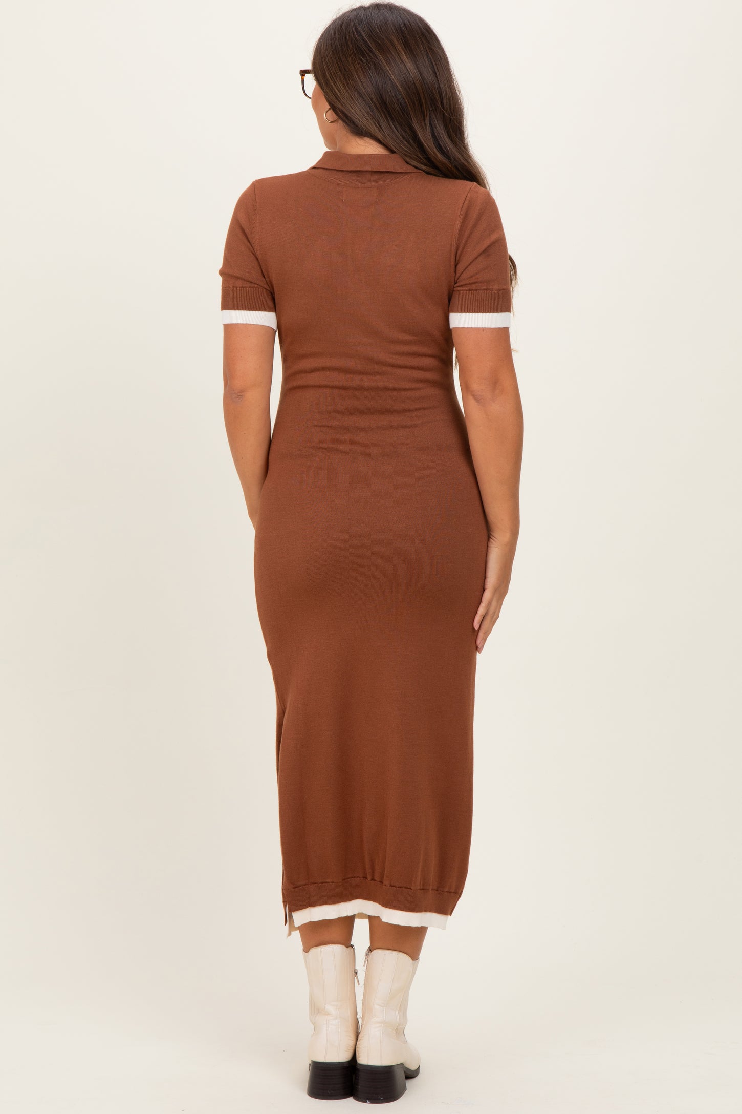 woman wearing a brown short sleeve maternity dress with contrasting white cuffs, shown from the back