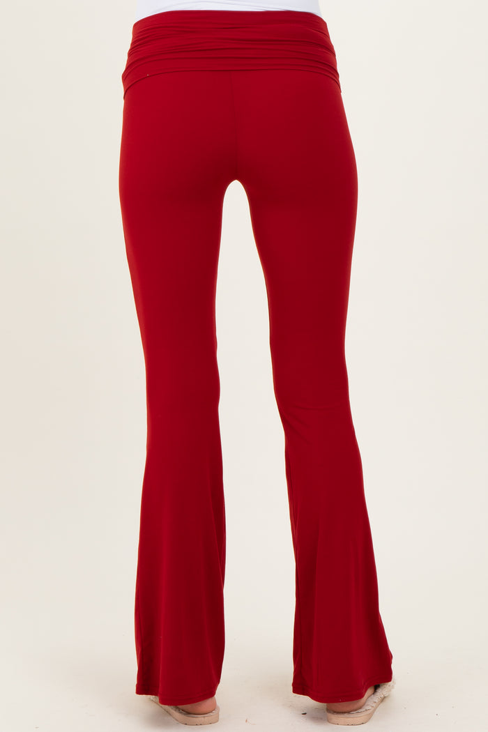 maternity wear in red flared pants with a soft, stretchy waistband, viewed from the back