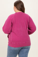 woman wearing a pink maternity plus sweatshirt, viewed from the back, with relaxed fit and ribbed hem