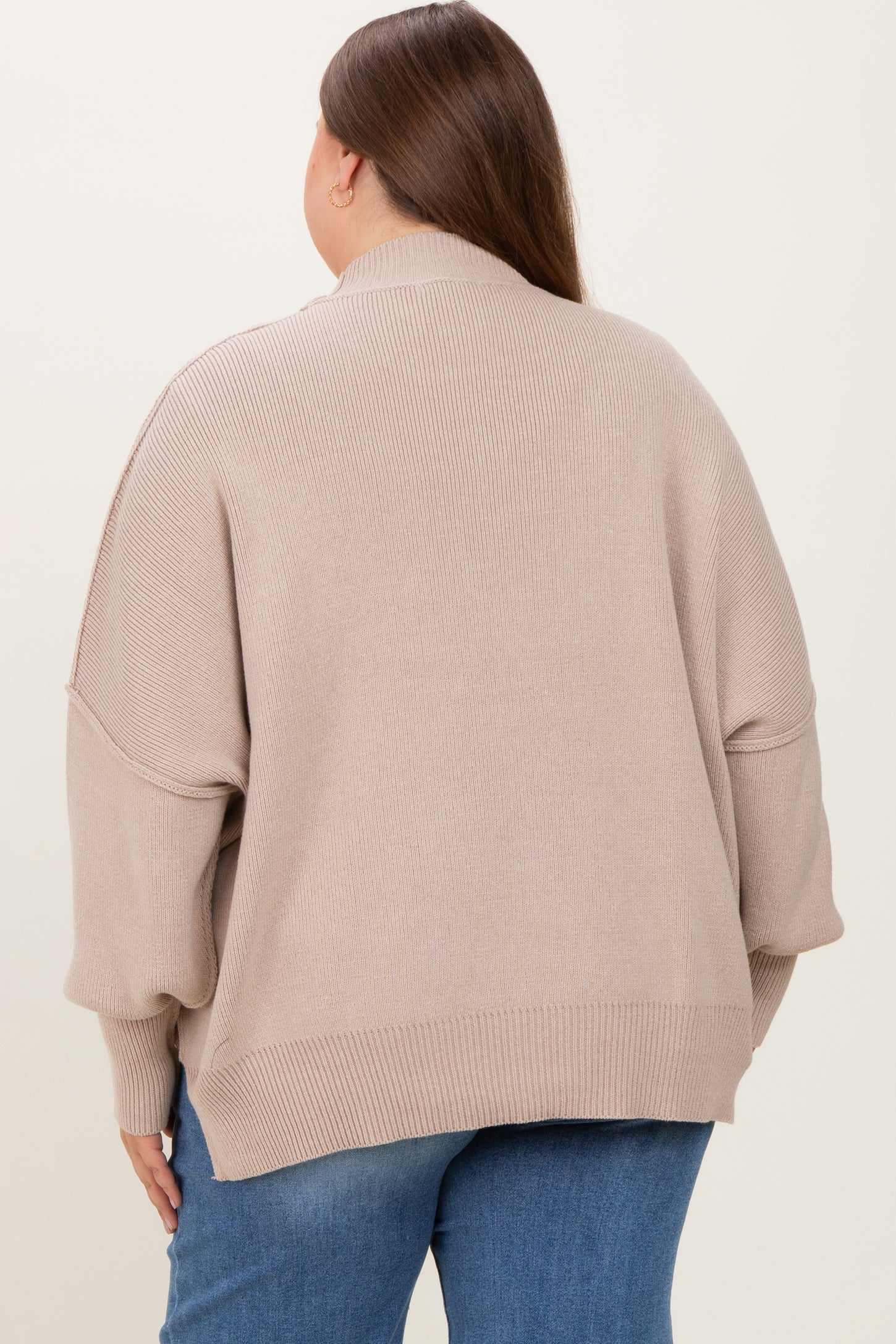 woman wearing a taupe oversized maternity sweater with a high neck and drop shoulders