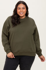 woman wearing an olive green plus size sweatshirt with a relaxed fit and long sleeves