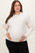 woman wearing a cream oversized maternity sweatshirt and holding her baby bump