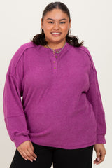 woman wearing a purple long sleeve plus size top with buttons and ribbed texture, paired with black pants