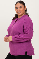 woman wearing a purple long sleeve plus size pullover with a zip collar and side slits