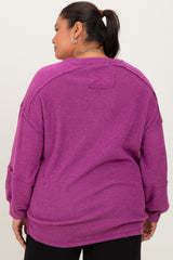 woman wearing a purple oversized plus size sweater with a relaxed fit and dropped shoulder seams
