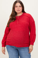 woman wearing a red maternity plus henley sweater with long sleeves and button details