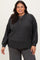 woman wearing a dark gray ribbed long sleeve top with buttons and relaxed fit, paired with gray pants