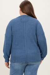 woman wearing a dark blue maternity plus sweater with a relaxed fit and back seam detail