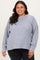 woman wearing a light gray oversized knit sweater with long sleeves and a relaxed fit