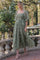 woman wearing a green floral embroidered maxi dress with puff sleeves and a tiered skirt