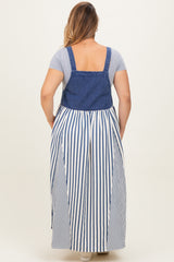 woman wearing a blue denim and white striped maternity plus maxi dress with a fitted top and loose skirt from the back