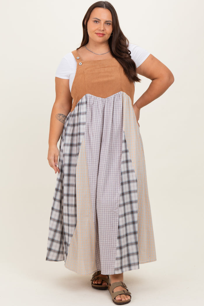 woman wearing a plus size color-blocked maxi dress with a brown top and plaid skirt sections