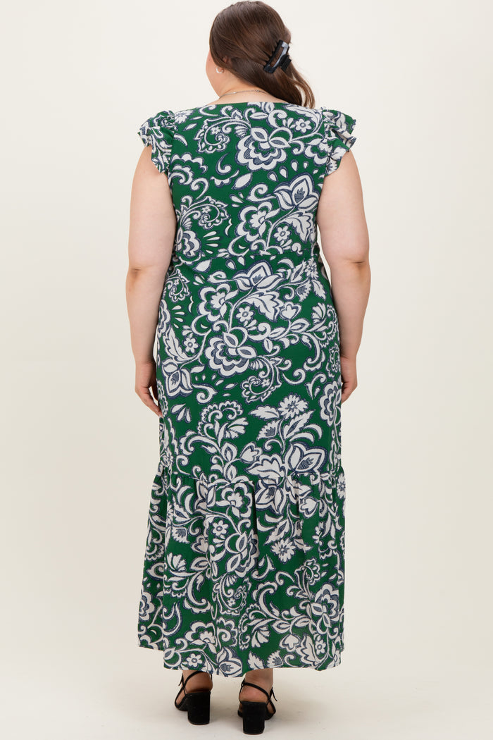 woman wearing a green floral print maternity plus maxi dress with ruffle sleeves, showing the back view