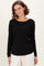woman wearing a black long sleeve ribbed top with a relaxed fit and gathered side details