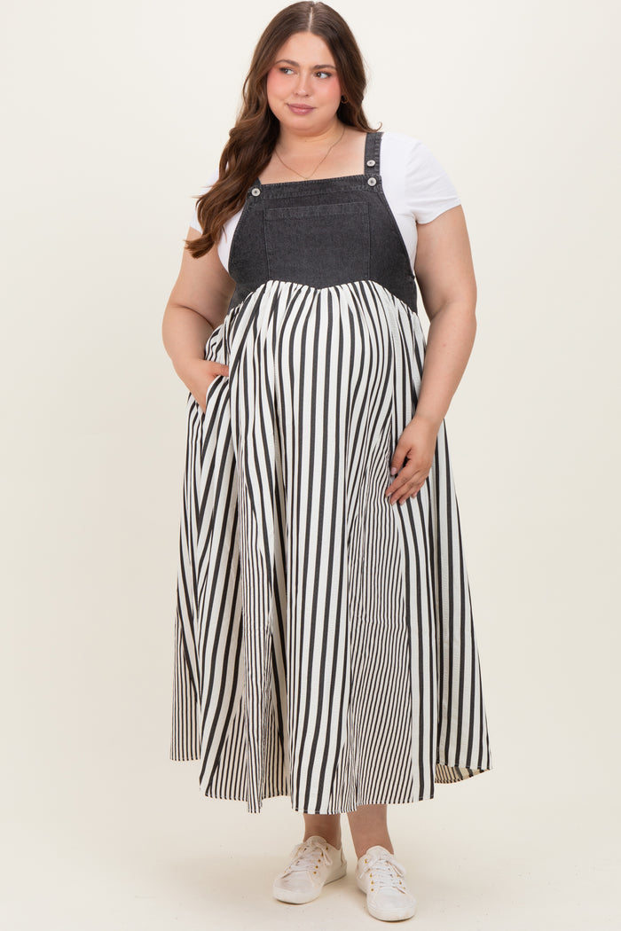 woman wearing a black and white striped maternity maxi dress with a denim-style bodice and a baby bump