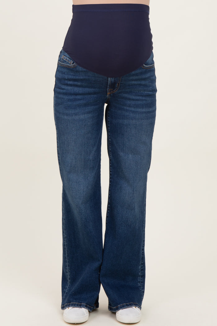 woman wearing a pair of dark wash maternity flared jeans with a high waistband