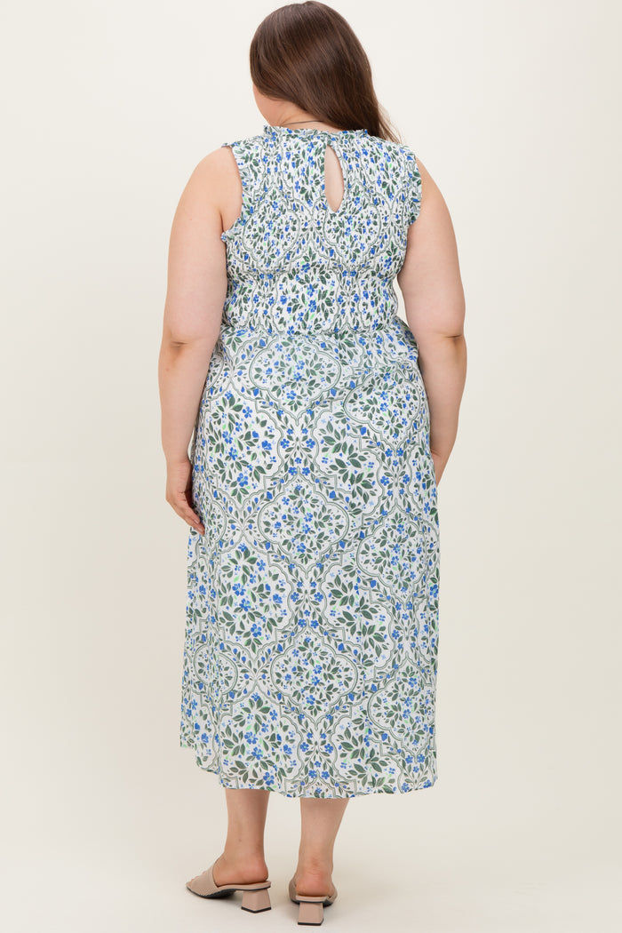 woman wearing a floral patterned maternity plus dress with a keyhole back detail and flowing skirt