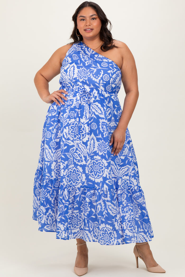woman wearing a blue floral plus size maxi dress with a one-shoulder design and tiered ruffles