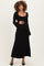 woman wearing a black long sleeve maternity dress and holding her baby bump