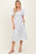 woman wearing a blue and white floral midi dress with short sleeves and pockets