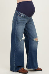 woman wearing dark blue distressed maternity wide-leg jeans with a navy belly panel and visible baby bump