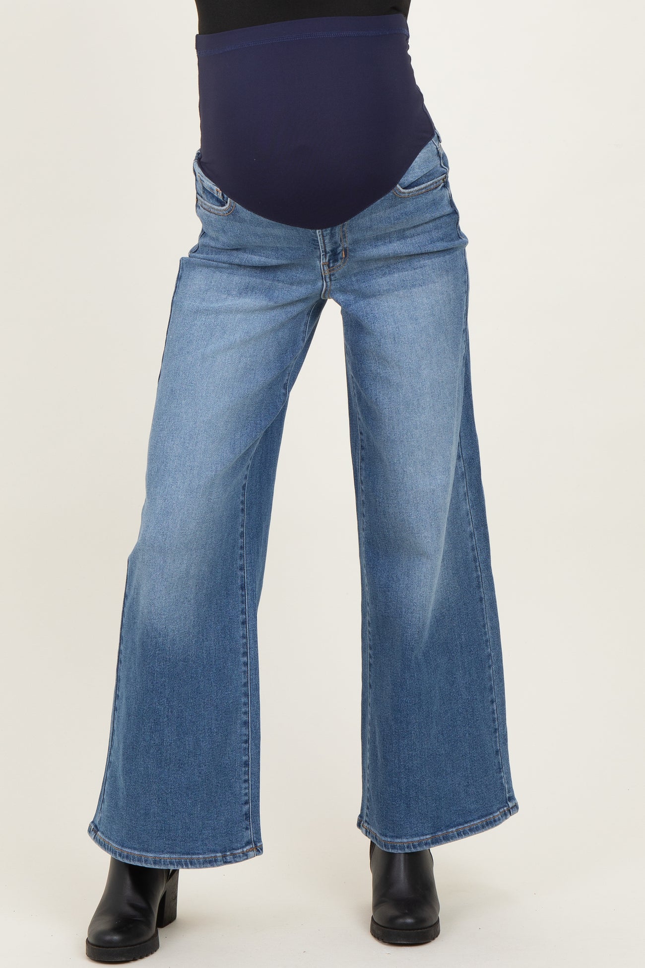 woman wearing light blue maternity wide-leg jeans with a dark blue belly panel