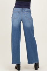 woman wearing a pair of blue wide-leg maternity jeans, showing the back view