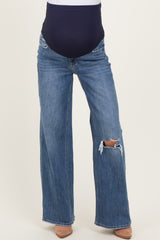 woman wearing maternity dark blue ripped wide-leg jeans with a stretchy navy waistband