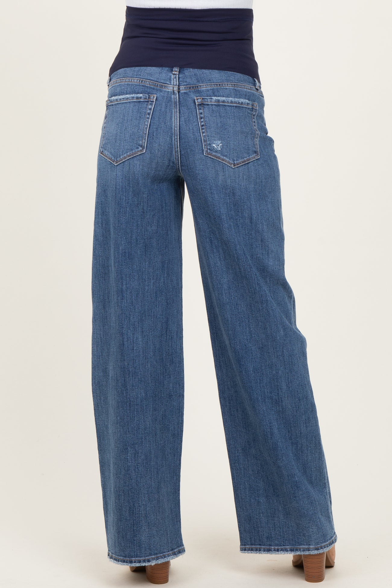 woman wearing dark blue wide-leg maternity jeans with a stretchy waistband, viewed from the back