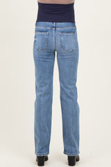 woman wearing a pair of light blue maternity jeans, showing the back view with a straight leg style and slight stretch