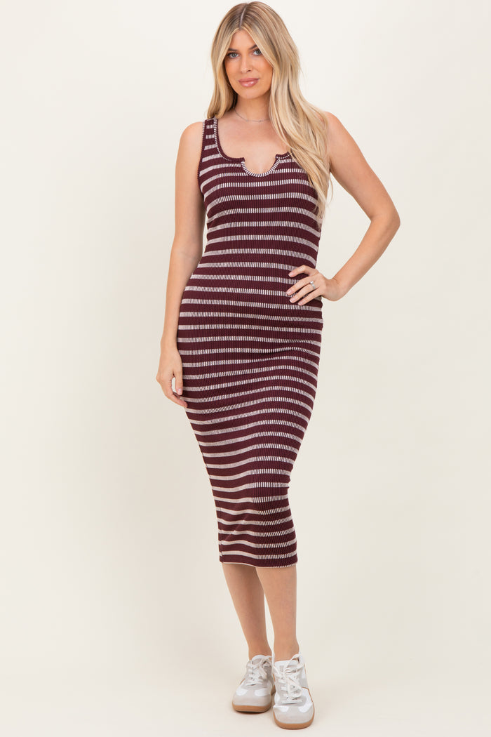 woman wearing a maroon and white striped ribbed midi dress with a scoop neckline and side slits