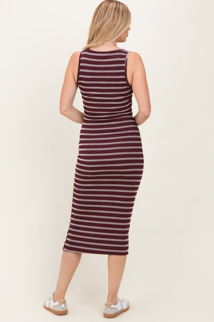 woman wearing a maroon and white striped sleeveless midi dress, showing the back view