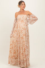 woman wearing a floral strapless maxi dress with puff sleeves and a visible baby bump