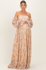 woman wearing a floral off-the-shoulder maxi dress and showing her baby bump